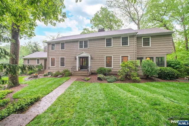 59 Green Hill Rd, Kinnelon Borough, NJ 07405 - colonial house with a front lawn and a chimney