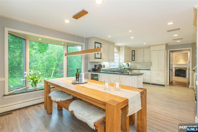 59 Green Hill Rd, Kinnelon Borough, NJ 07405 - dining space featuring crown molding, baseboard heating, light wood-style flooring, recessed lighting, and wine cooler