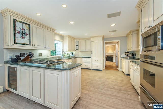 59 Green Hill Rd, Kinnelon Borough, NJ 07405 - kitchen with stainless steel appliances, cream cabinets, a peninsula, recessed lighting, and backsplash