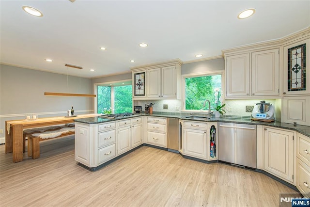 59 Green Hill Rd, Kinnelon Borough, NJ 07405 - kitchen featuring stainless steel appliances, a peninsula, cream cabinets, light wood finished floors, and healthy amount of natural light