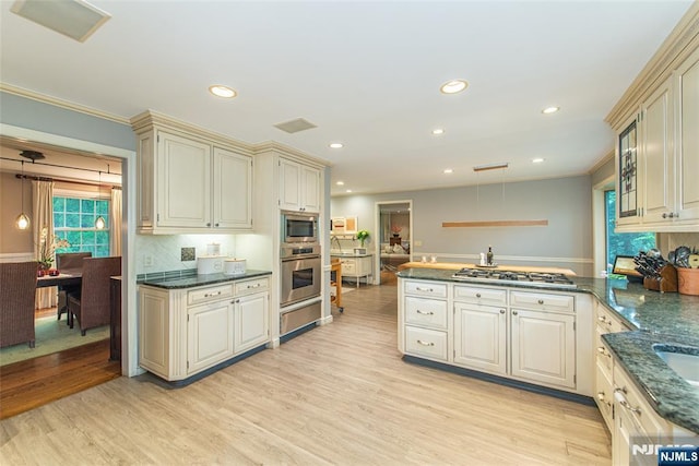 59 Green Hill Rd, Kinnelon Borough, NJ 07405 - kitchen with appliances with stainless steel finishes, a peninsula, cream cabinetry, light wood finished floors, and recessed lighting
