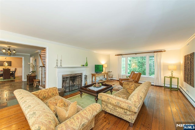 59 Green Hill Rd, Kinnelon Borough, NJ 07405 - living room featuring crown molding, a chandelier, a fireplace with flush hearth, and hardwood / wood-style flooring
