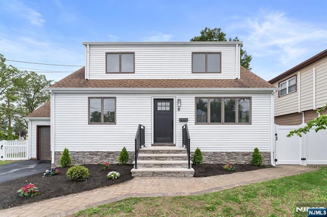 8 Marianne Ter, Secaucus, NJ 07094 - view of front facade with a gate, entry steps, a shingled roof, and stone siding
