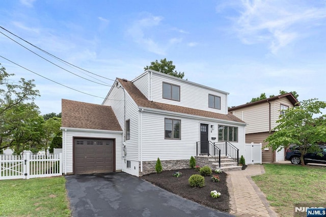 8 Marianne Ter, Secaucus, NJ 07094 - view of front of property with asphalt driveway, roof with shingles, an attached garage, and a gate