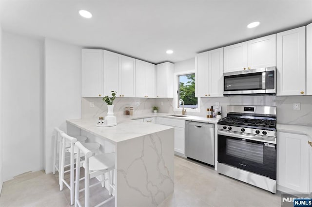 8 Marianne Ter, Secaucus, NJ 07094 - kitchen featuring appliances with stainless steel finishes, a breakfast bar area, white cabinetry, and recessed lighting