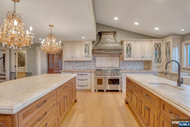 307 Freemans Ln, Franklin Lakes, NJ 07417 - kitchen featuring range with two ovens, custom range hood, light countertops, lofted ceiling, and a chandelier