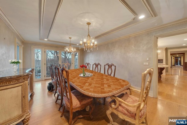 307 Freemans Ln, Franklin Lakes, NJ 07417 - dining area featuring light wood-style floors, a chandelier, crown molding, and a tray ceiling