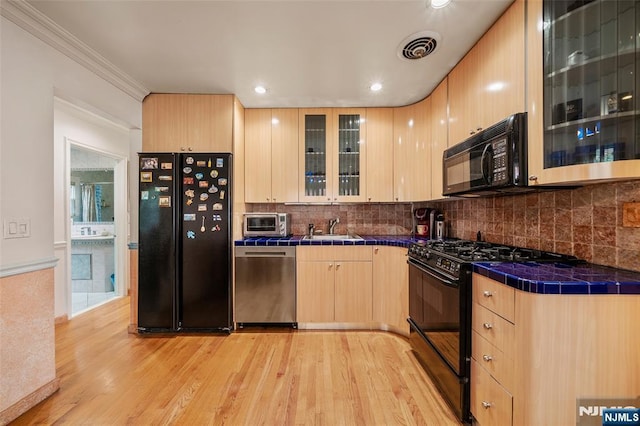 201 Oakdene Pl Unit C00E2, Cliffside Park, NJ 07010 - kitchen featuring black appliances, light brown cabinetry, tile countertops, light wood finished floors, and backsplash