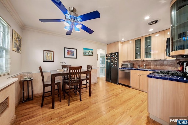 201 Oakdene Pl Unit C00E2, Cliffside Park, NJ 07010 - kitchen with appliances with stainless steel finishes, ceiling fan, light brown cabinets, tile counters, and light wood finished floors