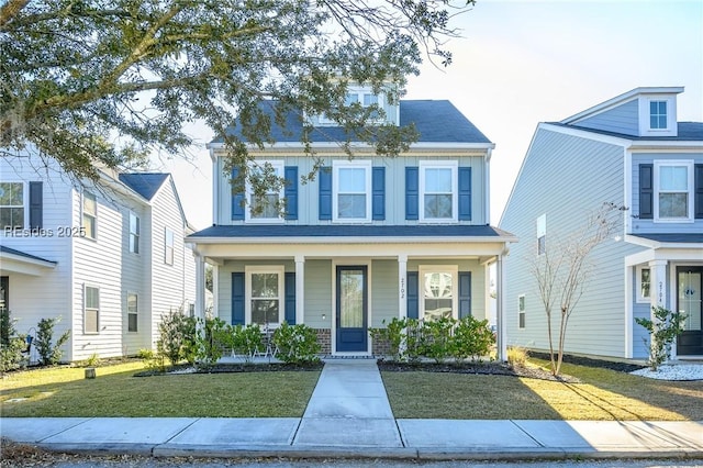 view of front of property with a porch and a front yard