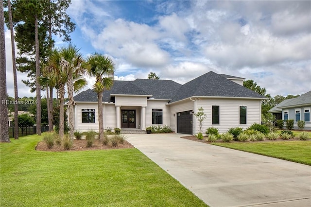 view of front of house featuring a garage and a front yard