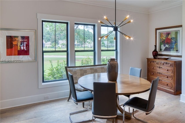 dining area with crown molding, a chandelier, and light wood-type flooring