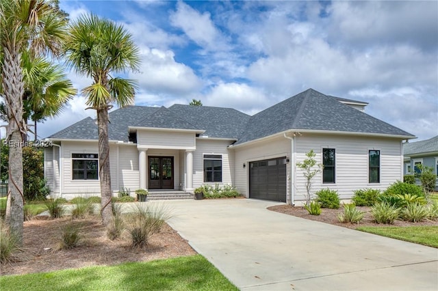 view of front of home with french doors and a garage