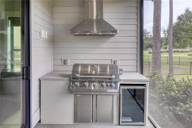 view of patio featuring an outdoor kitchen, beverage cooler, and grilling area