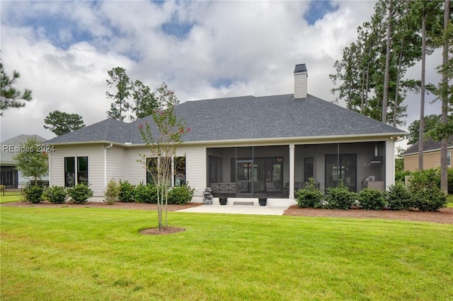 back of property featuring a yard, a sunroom, and a patio