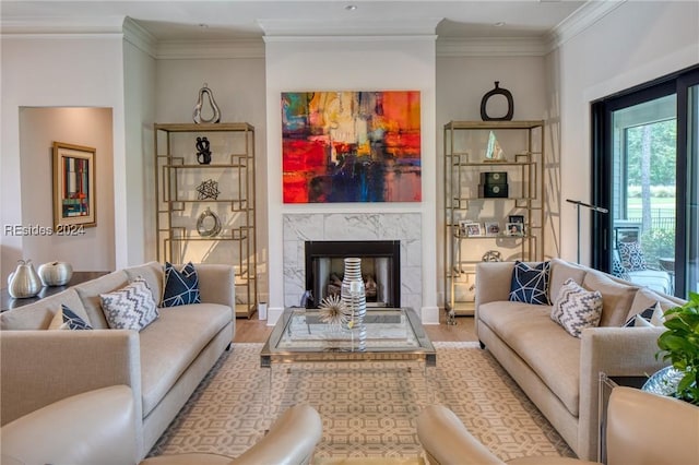 living room with ornamental molding, a fireplace, and light hardwood / wood-style floors