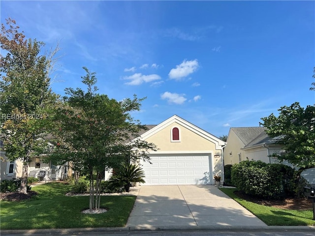 view of front facade with a garage and a front lawn