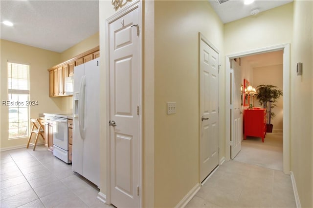 corridor with plenty of natural light and light tile patterned floors