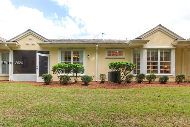 view of property exterior with a yard and a sunroom