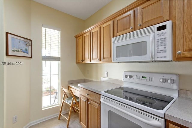 kitchen featuring white appliances and light tile patterned floors