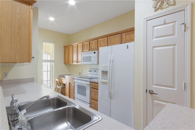 kitchen featuring sink and white appliances