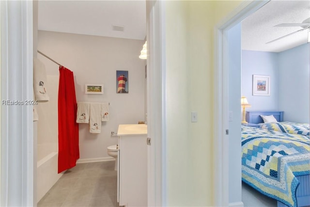 full bathroom featuring vanity, ceiling fan, toilet, a textured ceiling, and shower / bath combo with shower curtain