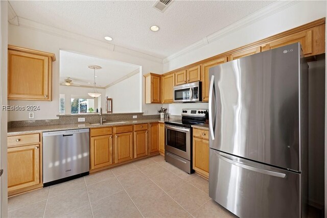 kitchen with stainless steel appliances, sink, light tile patterned floors, and a textured ceiling