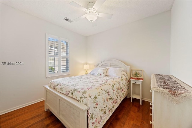 bedroom with dark wood-type flooring and ceiling fan