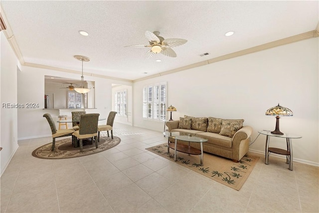 living room with ceiling fan, crown molding, light tile patterned floors, and a textured ceiling