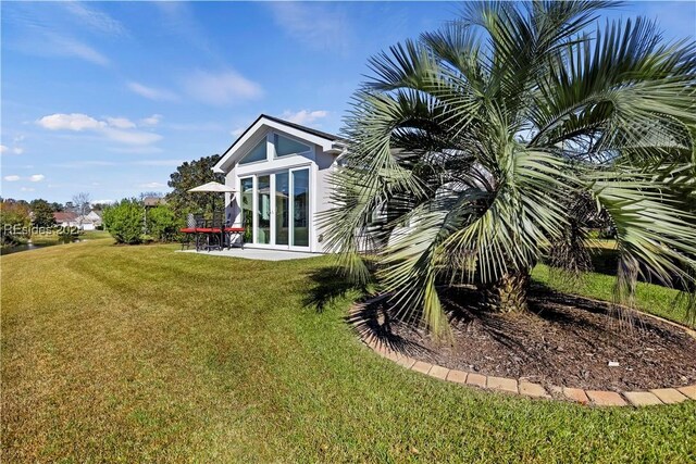 rear view of property featuring a yard and french doors