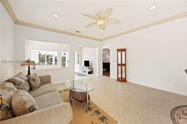 tiled living room with crown molding and ceiling fan