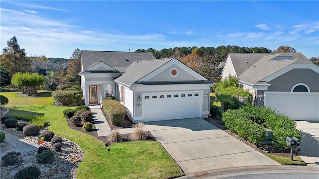 ranch-style home with a garage and a front yard