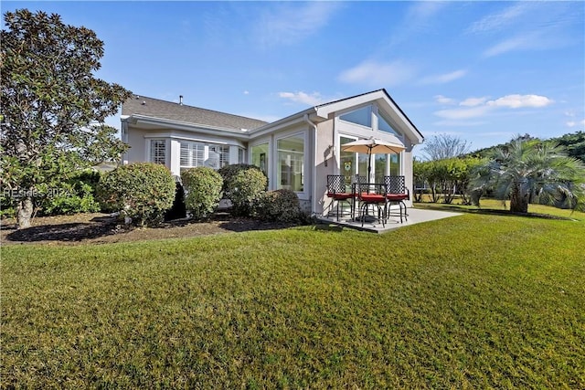 rear view of property featuring a yard and a patio