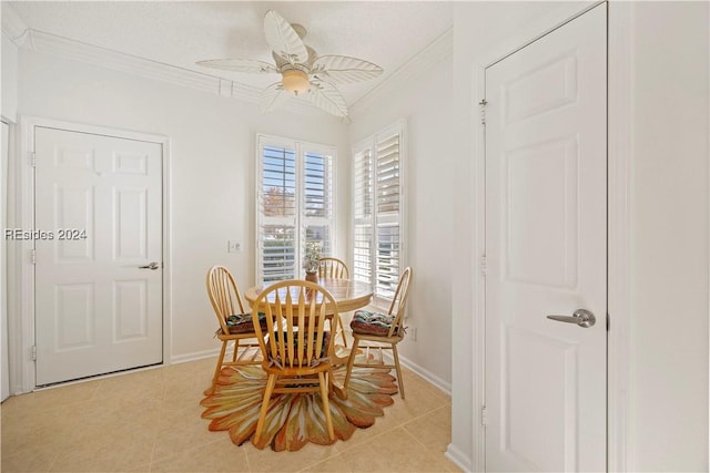 tiled dining space featuring crown molding and ceiling fan