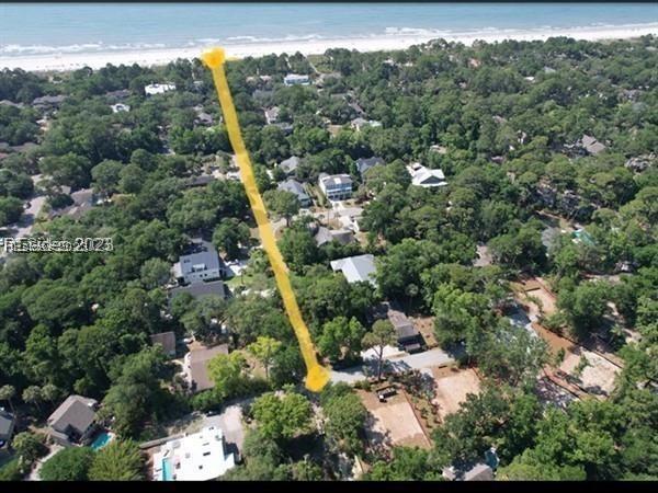 drone / aerial view featuring a water view and a view of the beach