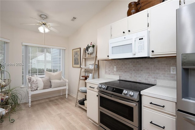 kitchen featuring light wood-type flooring, ceiling fan, stainless steel appliances, decorative backsplash, and white cabinets