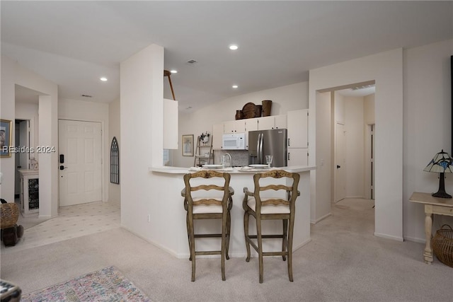 kitchen featuring stainless steel refrigerator with ice dispenser, tasteful backsplash, light carpet, kitchen peninsula, and white cabinets