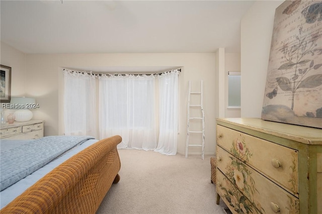 bedroom featuring light carpet