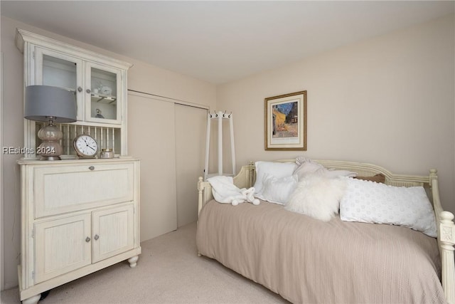 carpeted bedroom with a closet