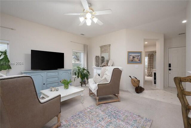 living room with light carpet and ceiling fan