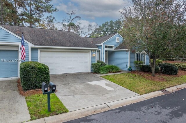 ranch-style house featuring a garage and a front lawn