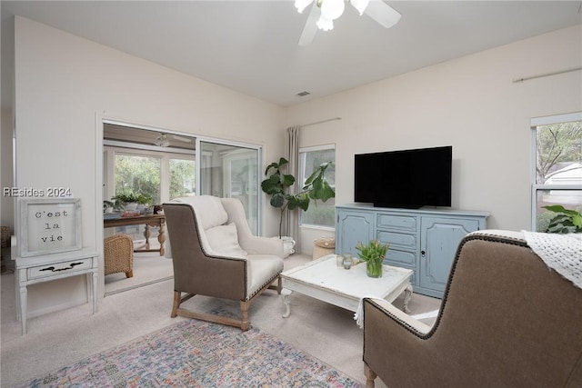 living room with light carpet and ceiling fan