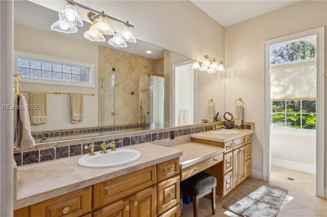 bathroom featuring vanity, plenty of natural light, a shower with shower door, and tasteful backsplash