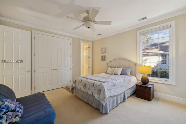 carpeted bedroom with multiple windows, ornamental molding, ceiling fan, and a closet