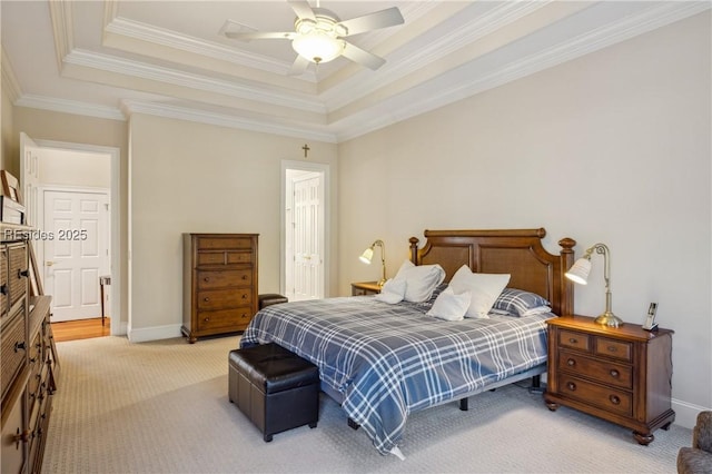 carpeted bedroom with crown molding, ceiling fan, and a raised ceiling