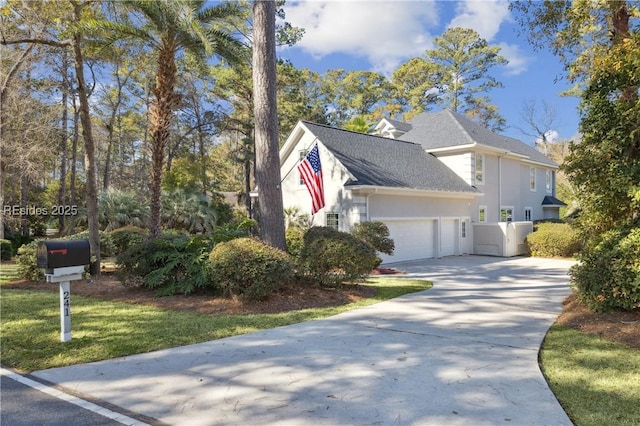 view of home's exterior with a garage and a yard