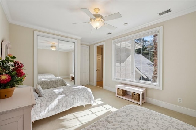 bedroom with crown molding, light colored carpet, and ceiling fan