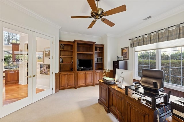 carpeted home office featuring ornamental molding, french doors, and ceiling fan