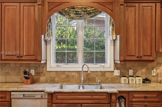 kitchen with dishwasher, light stone countertops, sink, and backsplash