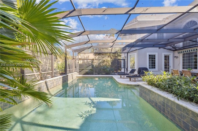 view of swimming pool with a patio and glass enclosure